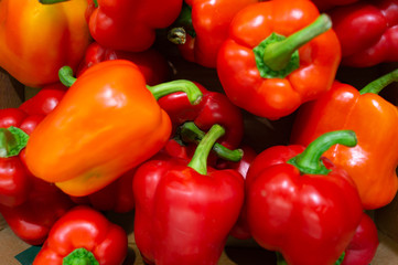 A lot of peppers are in a drawer in the store