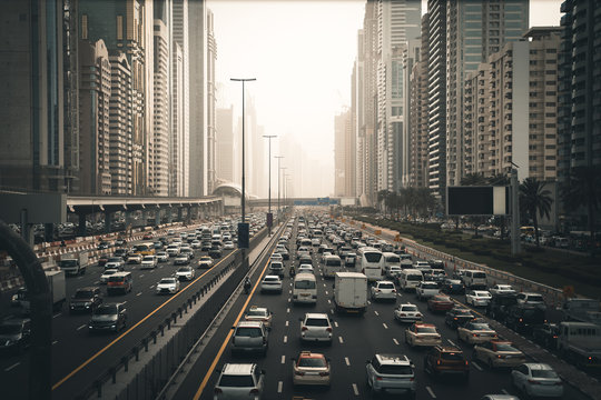 Rush hour with many cars on Dubai city road, traffic jam in downtown.