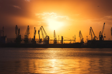 Fototapeta na wymiar Sea port and industrial cranes, Varna, Bulgaria.Sunset over the Varna lake