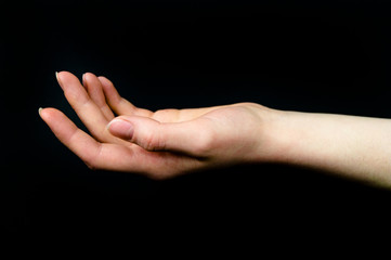 Hands on a black background show various action