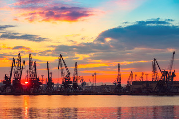 Obraz premium Sea port and industrial cranes, Varna, Bulgaria.Sunset over the Varna lake