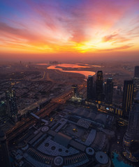Naklejka na ściany i meble Beautiful sunrise above Dubai skyline, United Arab Emirates, aerial panoramic view from Burj Khalifa.