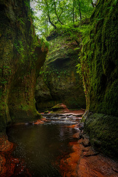 Inside of the Devil&rsquo;s Pulpit gorge, with running water, Dumgoyne, Scotland, UK