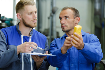 a mechanic man with digital multimeter testing ignition coil