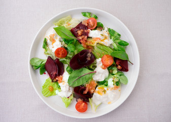Vegetarian salad of tomatoes, beets, lettuce,