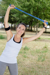 sporty woman holding skipping rope above her head