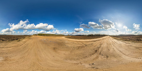 full seamless spherical hdri panorama 360 degrees angle view on gravel road among fields in spring day with awesome clouds in equirectangular projection, ready for VR AR virtual reality content
