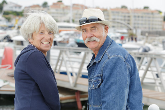 portrait of a senior couple at a marina