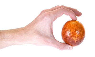 Blood orange in hand, isolated on white