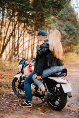 Plakat young couple on motorcycle laugh