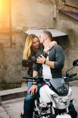 Naklejka na ściany i meble Couple on motorbike near old building