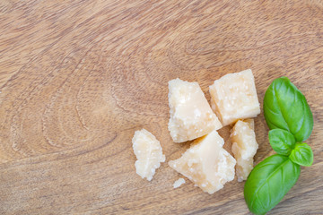 Pieces of parmesan cheese and a basil leaf