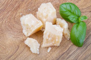 Pieces of parmesan cheese and a basil leaf