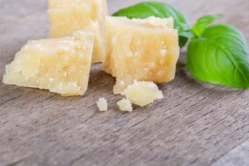 Pieces of parmesan cheese and a basil leaf