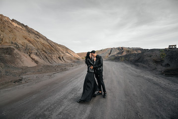 Asian couple in love in black leather clothes walking in nature. Style, fashion, love