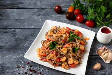 Soba noodles with shrimps and vegetables - asian food creative concept.
