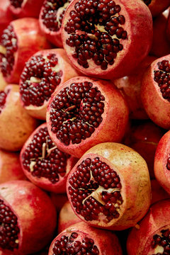 Stacked and Cut Pomegranates at Market