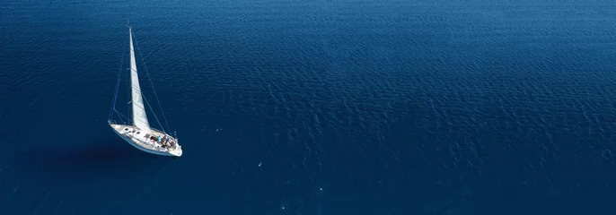 Foto auf Acrylglas Aerial drone ultra wide photo of beautiful sail boat cruising in Aegean deep blue sea © aerial-drone
