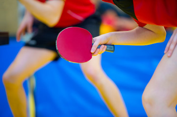 Ping pong table, woman and man playing table tennis with racket and ball in a sport hall
