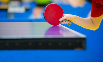 Close up of a woman hands holding table tennis rocket
