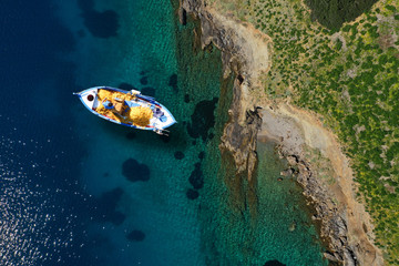 Naklejka premium Aerial drone photo of beautiful traditional fishing boat in island of Crete at spring, Greece