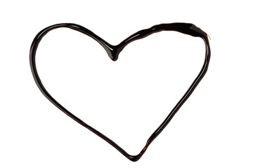 Heart shape painted with chocolate syrup on white background