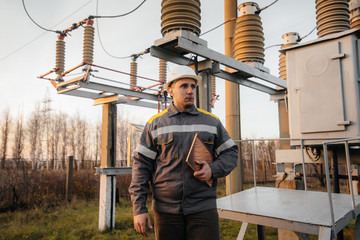 The energy engineer inspects the equipment of the substation. Power engineering. Industry