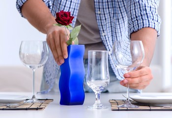 The man alone preparing for romantic date with his sweetheart