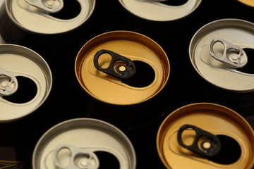 Silver and golden color open drink / beverage / beer cans flat lay close up macro