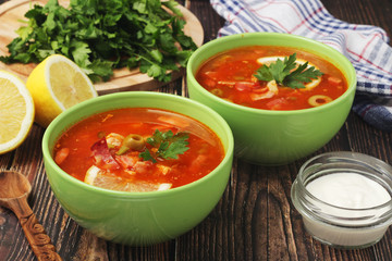 Two bowls with traditional Russian soup solyanka	