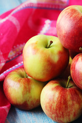 Several ripe red apples on the wooden table