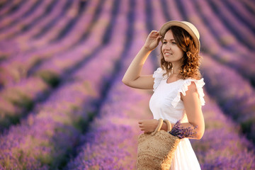 portrait of a happy pretty young woman in lavender field