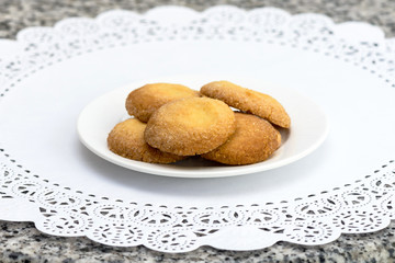 Shortbread biscuits sprinkled with sugar on a white napkin