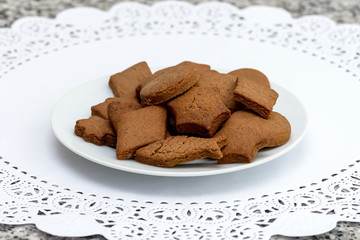 Butter chocolate cookies of different shapes on a white napkin