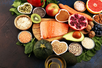 Fototapeta na wymiar Healthy food clean eating selection: fish, fruit, vegetable, cereal, leaf vegetable on rustic background