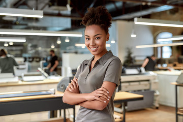 Fototapeta premium Begin a great things. Smiling african american office worker posing with folded arms