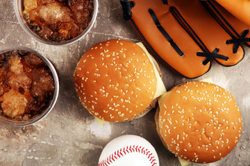 burger on the table with softdrink cola. Baseball party food with balls for the playoffs