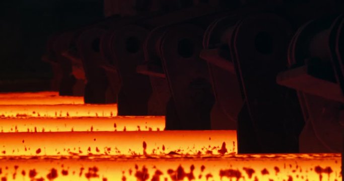Iron foundry. Continuous casting machine. Steel billet moving through the pipeline.