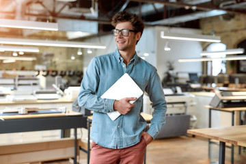 Just best, just legendary. Young businessman posing in office