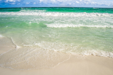 Turquoise waters flowing over the shore
