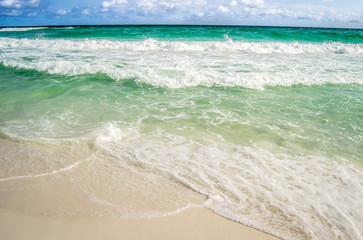 Turquoise waters flowing over the shore