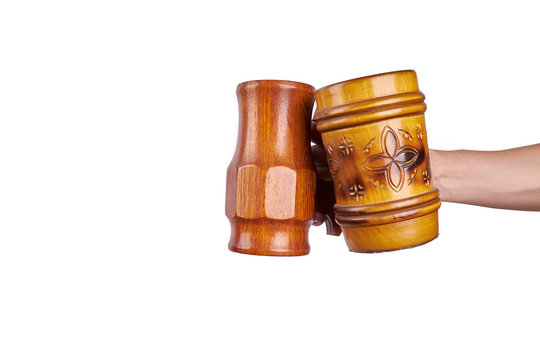 a wooden beer mugs in hand isolated on a white background.