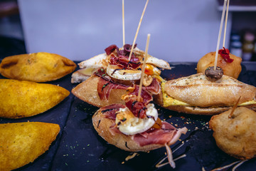 Naklejka premium Varieties of snacks called pinchos in bar in San Sebastian city also called Donostia in Basque Country, Spain