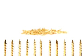 Gold screw isolated on white. Yellow zinc chipboard screws, full thread close up