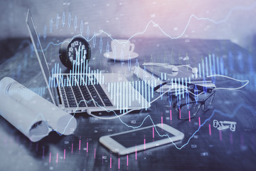 Stock market chart hologram drawn on personal computer background. Double exposure. Concept of investment.