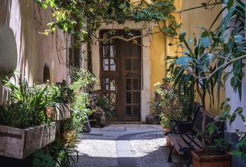 Fototapeta na wymiar Narrow street in old town of Catania city on Sicily Island and autonomous region of Italy