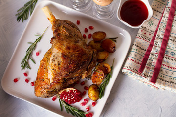 Roast leg of lamb with potatoes, pomegranate and rosemary. View from above, top view
