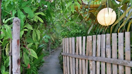 bamboo door leading to a jungle garden