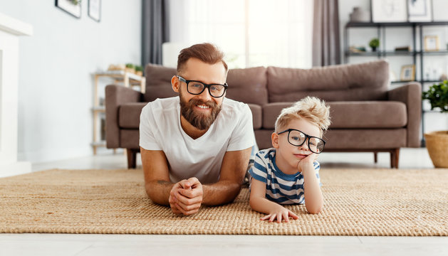 Father's day. Happy funny family son and dad with glasses