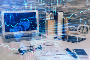 Multi exposure of graph and financial info and work space with computer background. Concept of...